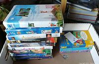 Stack of 10 VHS tapes with visible titles including Antz and Anastasia arranged in a box
