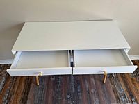 Top view of desk with both drawers pulled open, showing interior detail and drawer construction.