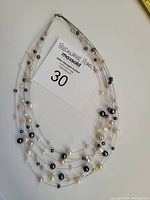 Top view of the 7 strand freshwater pearl necklace showing the various colored pearls on thin wires.