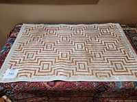 Top view of the small Jaipur patterned carpet on top of medium traditional carpet