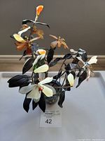 Full view showing floral tree with multi-colored jade flowers and dark jade leaves in cloisonné vase.