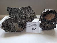 Two vintage Indonesian Batik stamps side by side showing detailed carved floral and leaf motifs on the print faces.