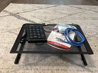 Full lot displayed together including the monitor riser, USB numeric keypad, and CAT5e cable in packaging.