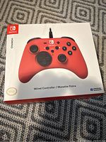 Top view of the HORIPAD controller box showing the red wired controller image and branding.
