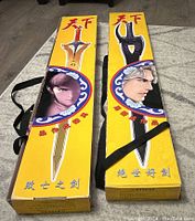 Two boxed Storm Riders prop swords, bright yellow box with illustrated anime characters and Chinese text