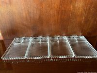 Top view of the vintage Hazel Atlas Snack Sip & Smoke clear glass tray showing all four compartments with ribbed pattern and beaded edges.