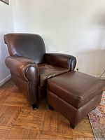Side-angle view of recliner and ottoman on hardwood floor
