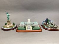 Overview of all three miniatures side by side: Statue of Liberty on left, US Capitol in center, Fenway Park on right