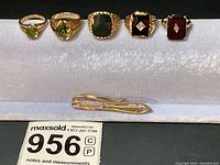 Overview of all six gold jewelry pieces on display