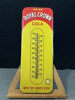 Front view of the enamel-coated metal thermometer showing full graphics, gauge and mounting holes.