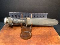 Side view of the utility cutting utensil showing blade and grip with measuring scale.