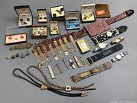 Overview photo showing entire collection of men's accessories, cufflinks, tie tacks, watches, bolo ties.