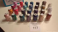 All 27 spools of machine embroidery thread arranged in rows showing diverse colors and new wrappers.