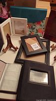 Overview of the collection showing multiple photo frames, business card wallet, and one of the wooden plate holders