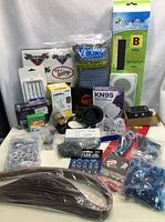 Full lot showing various hardware, accessories, and safety equipment arranged on a white table.