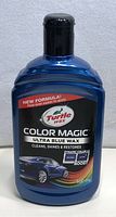 Blue bottle of Turtle Wax Colour Magic Ultra Blue car wax cleaner, 500ml with black cap and product label showing branding and features