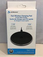 Photo of the front of the unopened box for the Adreama Fast Wireless Charging Pad and Wall Charger. Box includes brand logo, charging specs, and included accessories.