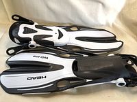 Photo showing pair of new Head Volo One black and white snorkelling/scuba fins with adjustable heel straps, side vents, and branding.