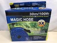 Boxed Magic Hose 100ft showing branding, expansion features, and connectors