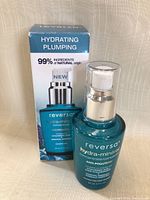 Photo of the Reversa hydra-mineral hydrating plumping serum bottle in front of its original box.