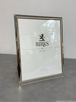 Front view of the polished silver Birks photo frame with beaded edges and placeholder photo insert.