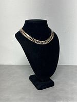 Full view of curb chain necklace displayed on black bust