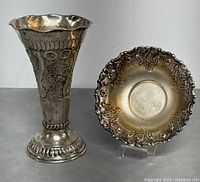 Photo showing both silver plated vase with engraved designs and decorative bowl with scalloped floral edge.