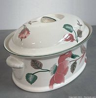 Side view of the Mikasa oval lidded casserole dish showing floral design and handle details