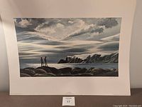 Full view of the print showing the entire image with two figures on rocky shore and distant cliffs under dramatic sky.