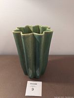 Front view of the Beauce ceramic pottery vase showing the fluted star-shaped design and celadon green glaze.