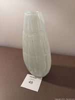 Front angle view of the white glass vase showing the textured web pattern and smooth glossy finish.