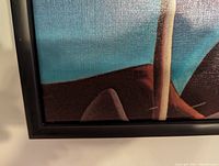 Close-up of lower left corner showing printed canvas texture and black frame edge