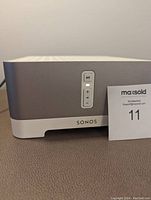 Front view of Sonos Connect: Amp showing aluminum front with play/pause and volume controls