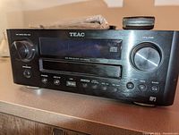 Front view of TEAC CR-H500 stereo receiver showing volume and tuning knobs, CD player slot, and input ports