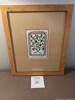 Framed limited edition print "Twining Hedera" by Nancy Johns shown from front within simple wooden frame.
