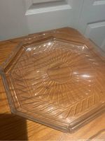 Clear octagonal crystal platter showing its faceted edges and etched decorative pattern