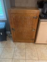 Front view of the Barnet vintage wooden cooler/fridge showing door with metal hinges and latch, wood condition with wear and discoloration.