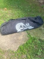 Black carrying bag with CLAM Base Camp Thermal logo for the ice fishing hut.
