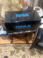Black box of IMAX Ultimate Collection with branding and small preview images of movies along the bottom.