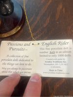 Close up of the doll's identification card showing it is number 302/1000 from the Passions and Pursuits series by Avonlea Traditions.
