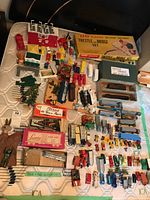 Overview of lot on table including boxed trestle set, cars, accessories