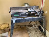 Full view of the Simpson Sears jointer/planer machine standing on metal legs in a garage.