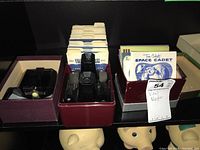 Photo of two vintage View-Master viewers and boxes of reels with labels visible