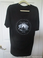Full view of black Alice in Chains Rainier Fog Tour T-shirt hanging on hanger with front design visible.