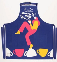 Full front view of Blue Q apron showing colorful woman graphic and steaming coffee cups with adjustable neck strap and long waist ties.