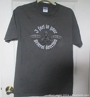 Full front view of gray t-shirt hanging on a door, showing the Monty Python graphic and text