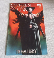 Front cover of the comic book featuring artwork of two characters, one with wings, against a red to blue gradient background with title 'Stephen King The Dark Tower Treachery'.