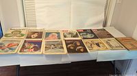 Collection of multiple antique magazines laid out on a table, showing covers of various publications and issues as listed by the seller.