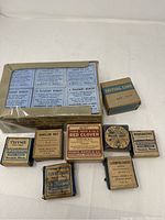 Full lot showing all 8 vintage apothecary medicine boxes with visible labels.