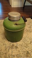 Angled front view of the vintage green Therma Jug showing the screw top lid and black handle grip.